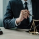 A business owner going over documents to classify their business, struggling with choosing the right business entity and considering bringing in an attorney.
