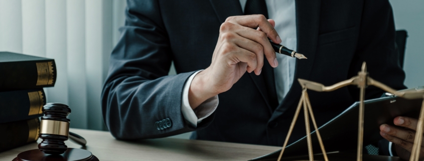 A business owner going over documents to classify their business, struggling with choosing the right business entity and considering bringing in an attorney.