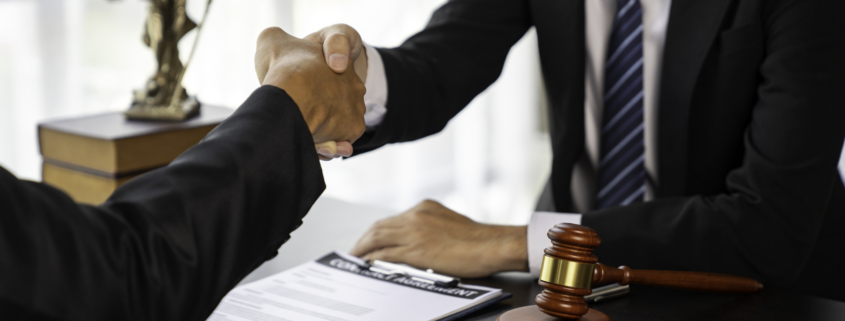 An image of two people closing a deal after deciding to embark on a year-end M&A sprint and answering the question: Why Rush to Close M&A Deals Before the End of the Year?